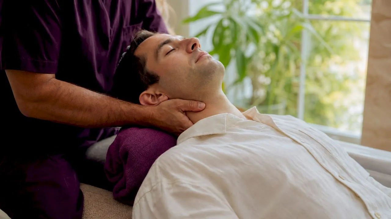Hands performing a therapeutic neck massage